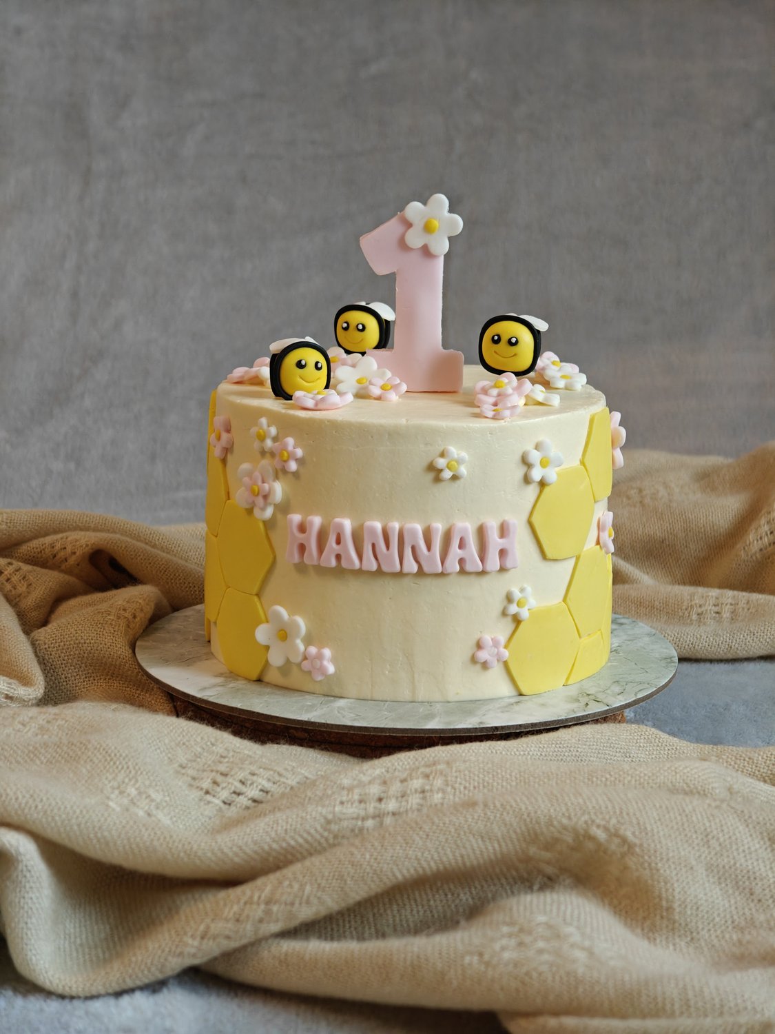 Children bee birthday cake with fondant bees and honeycomb